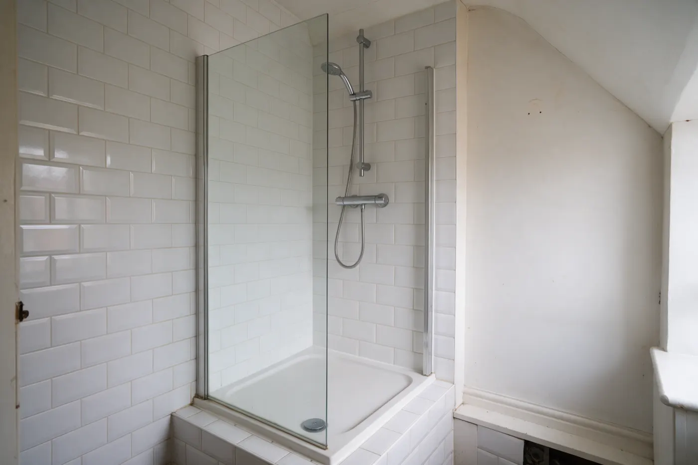 A walk-in shower with a glass screen where a bath used to be