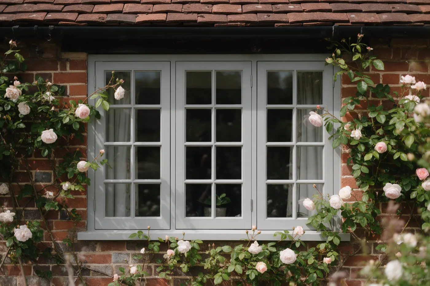 Painted timber flush casement windows on a cottage